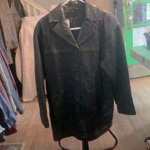 Black leather jacket, four button front. Smooth inner lining.